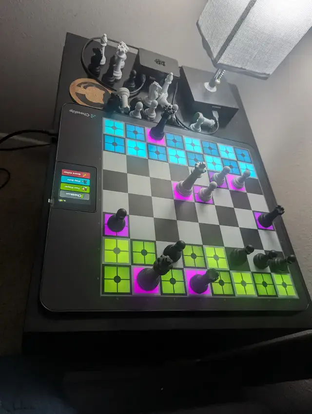 White king checkmated on a Chess Up 2 board by black with some squares lit up